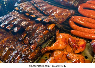 Barbecue Pit. Texas Classic Traditional Open Barbecue Pit. Fueled By Mesquite Smoke Chips. Racks Of Pork Ribs, Beef Ribs, Briskets Seasoned With Spices And Doused In Special Secret Sauce Bbq Sauce. 