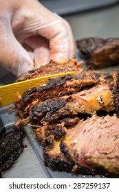 Barbecue Pitmaster Cuts Through A Delicious Cut Of Beef Brisket