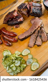 Barbecue Platter. Texas BBQ Platter: Pork Ribs, Brisket, Pork Sausage, Pickles, Bbq Sauce, Potato Salad, Baked Beans.