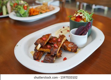 Barbecue Pork Rib - Grilled Pork Baby Ribs With Bbq Sauce Topped With Pomegranate Served With Sweet Potato Fries, Fresh Vegetable Salad And Creamy Mashed Potatoes, Healthy Food Concept.