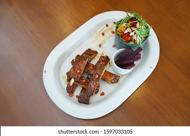 Barbecue Pork Rib - Grilled Pork Baby Ribs With Bbq Sauce Topped With Pomegranate Served With Sweet Potato Fries, Fresh Vegetable Salad And Creamy Mashed Potatoes, Healthy Food Concept.