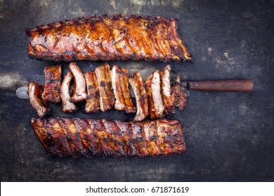 Barbecue Pork Spare Ribs as top view on an old rusty metal sheet 
