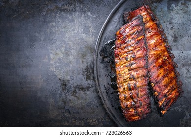 Barbecue Pork Spare Ribs As Top View On An Old Rustic Board 