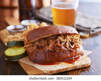 Barbecue Pulled Pork Sandwich With Beer In The Background