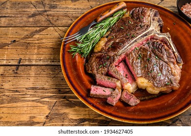 Barbecue Roast Porterhouse Or T Bone Beef Meat Steak On A Rustic Plate. Wooden Background. Top View. Copy Space.