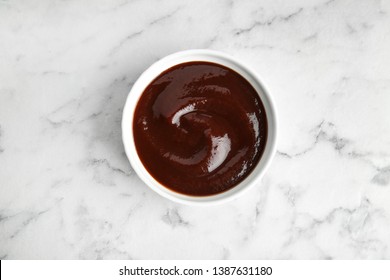 Barbecue Sauce In Bowl On Marble Background, Top View