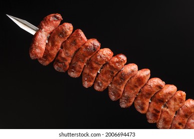 Barbecue Sausages On Skewers On Black Background.