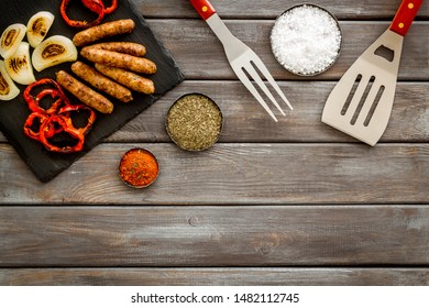 Barbecue, Sausages, Vegetables And Kitchen Tools On Wooden Background Top View Mock Up