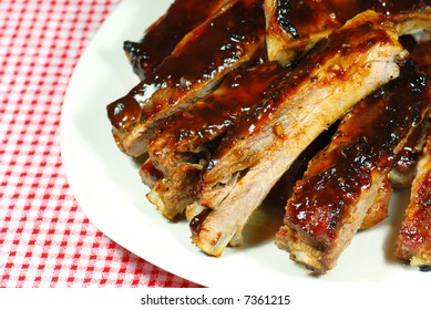 Barbecue Spare Ribs On A Plate With A Checkered Tablecloth