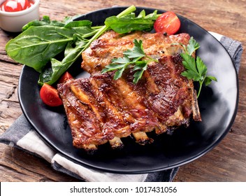 Barbecue Spare Ribs On An Rustic Wooden Table