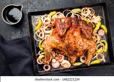 Barbecue spatchcocked barbecue chicken al mattone chili with peperoni and onions as top view on an old metal sheet  - Powered by Shutterstock