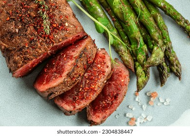 Barbecue steak with green asparagus and red wine. Healthy dinner or lunch.