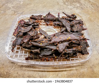 Barbecue Taste Spicy Dried Beef Jerky Strips On The Fruit Dryer Shelf