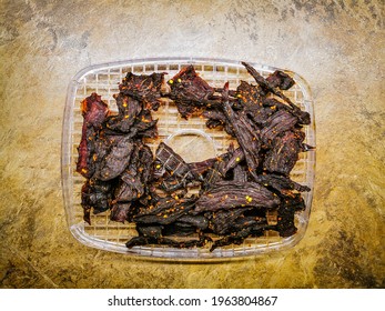 Barbecue Taste Spicy Dried Beef Jerky Strips On The Fruit Dryer Shelf