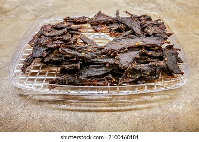 Barbecue Taste Spicy Dried Beef Jerky Strips On The Fruit Dryer Shelf