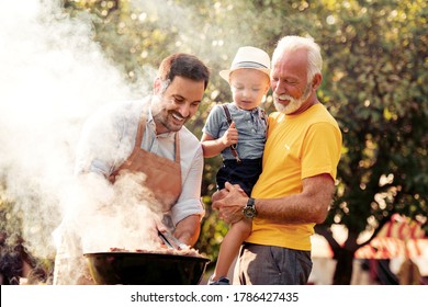 Barbecue time.Happy big family make barbecue in their garden. - Powered by Shutterstock