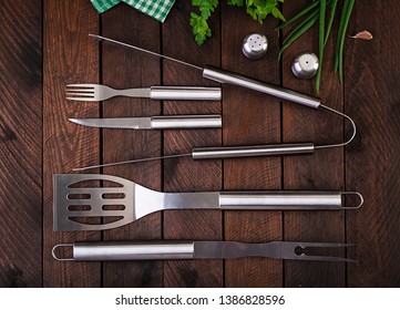 Barbecue Tools on wooden table. Flat lay, top view