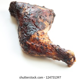 Barbecued chicken leg also known as Jerk Chicken - Caribbean style. Shallow DOF.