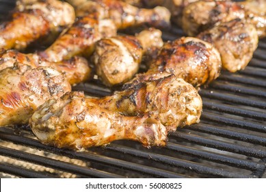 Barbecued Jerk Chicken drumsticks on the Grill