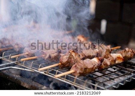 Barbecued liver shish kebab, Turkish traditional popular meal barbecued liver shish kebab. Closeup photo with copy space. Meats cooked under the fumes of charcoal. Smoked food flavor concept idea.