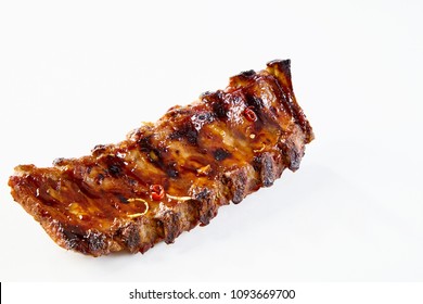 Barbecued and marinated sticky spare ribs on a white background with copy space.