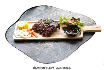 Barbecued spareribs serving with vegetables, salad and sauce on wooden platter.  Grey wood as background.  Restaurant, home cooking cuisine idea. - Shutterstock ID 2227462837