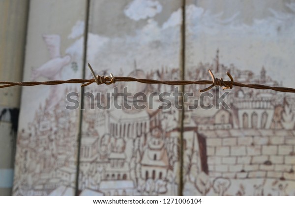 Barbed\
fence, old city of Jerusalem, Art and writings on the wall in\
Bethlehem, between Palestine Westbank and\
Israel