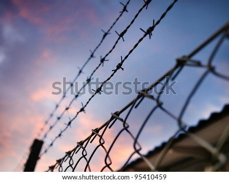 Similar – Fence with a barbed