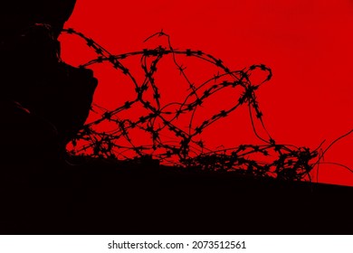 barbed wire against red background  silhouette barbwire imprisonment jail confinement, gaol, constraint, bond concept