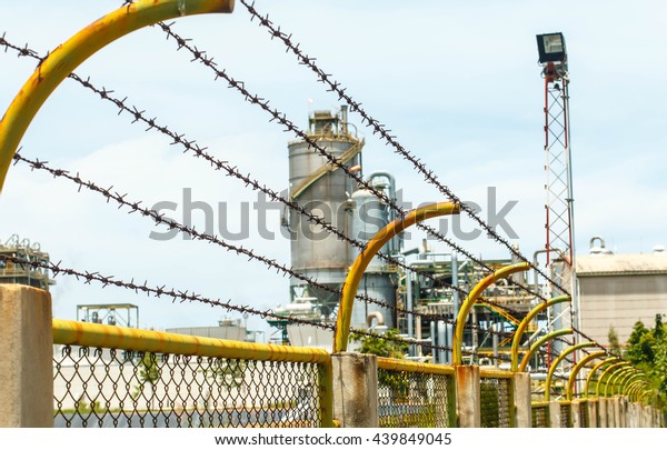 Barbed wire backdrop petroleum industry Ra yong\
in Thailand.