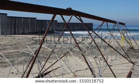 Barbed wire blocks closer access to the border fence at the beach between San Diego and Tijuana.                               