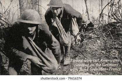 Barbed Wire Cut - Early 1900's WWI postcard depicting Americans going through cut barbed wire with bags of grenades toward Germans.