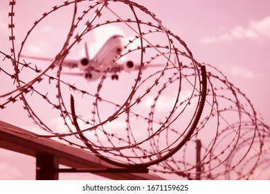 Barbed Wire Fence Border And Passenger Jet Plane On Backround.Air Traffic And Airports Closed Due Quarantine Of Coronavirus Outbreak Alert Danger. Restrictions Measures Prevent Virus Spread