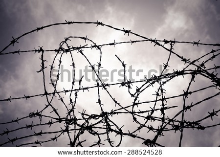 Similar – Fence with a barbed