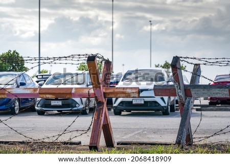 Barbed wire fence of the parking lot. Cars parked at outdoor car parking lot. Car was seized by a lending company. Financial crisis impact on car loan. Used car business. Auto leasing and insurance.