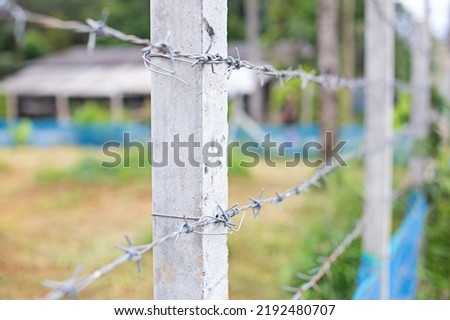 barbed wire fence posts image focusing on pillar
