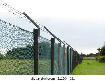 Barbed Wire Fence Protecting A Border From Illegal Trespassing From Refugees, Migrants And Illegal Aliens. 