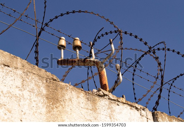\
Barbed wire fence. Fence with protection by\
electricity. Security. Border.\
Protection.
