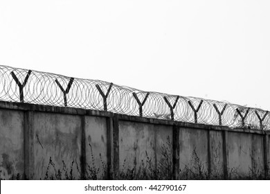 Barbed Wire Fencing Around A Prison.