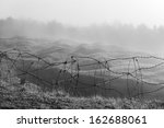 Barbed wire in the Fort de Douaumont, Verdun, France. We can see the craters on the lawn in the background.