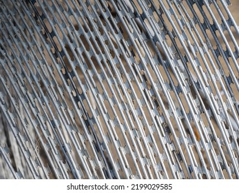 Barbed wire made of steel. Spiked barrier to restrict movement. Barbwire background. Fragment coil of barbed wire at border. Barbwire close-up. Barbwire metal fence. Territory protection concept