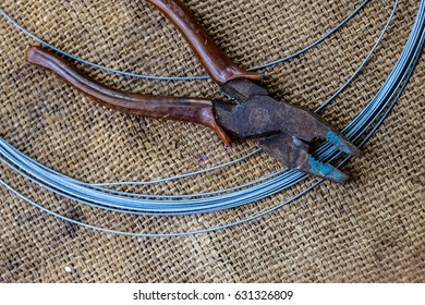 Barbed Wire And Old Cutter On Hemp Sack.