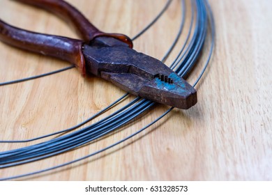 Barbed Wire And Old Cutter On Wood Table