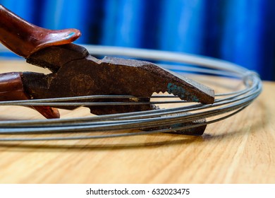 Barbed Wire And Old Cutter On Wood Table