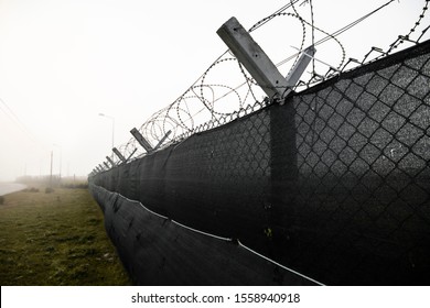 Barbed Wire On The Fence. Jail Fence Prison In Hopeless Foggy Day