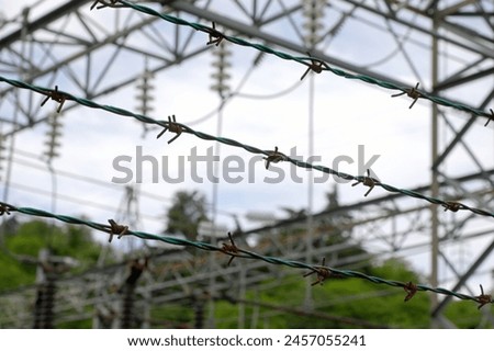 barbed wire on the impassable border in dark dramatic tones of the protected area without people without people