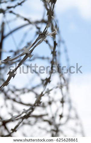 Barbed wire on sky background.