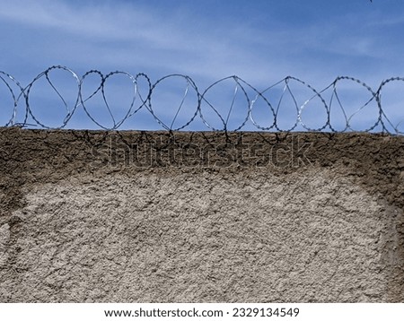 barbed wire on the wall of the house
