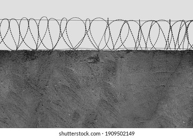 Barbed wire over a concrete wall. The concept of deprivation of liberty or restriction of territory in industrial production. no people. Copy space. front view.