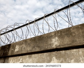 Barbed wire in a prison or in the army. Sharp military security fence. Close-up image. Crossed barbed wire. Prison barbed wire. Concentration camp. Used for background or texture. Selective focus.